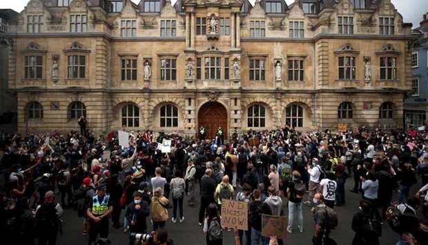 Demonstrators protest for the removal of a statue of British imperialist Cecil Rhodes at Oriel College in Oxford yesterday.