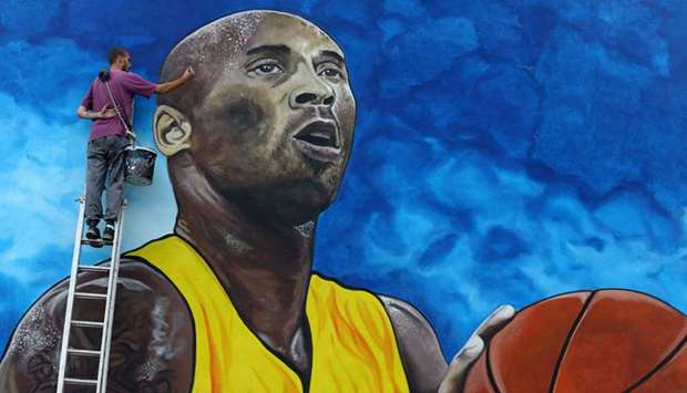 Artist Deni Bozic paints the last details on his tribute mural honouring former Los Angeles Lakersu2019 star Kobe Bryant on a school building wall in Gradiska, Bosnia, on Monday. (Reuters)