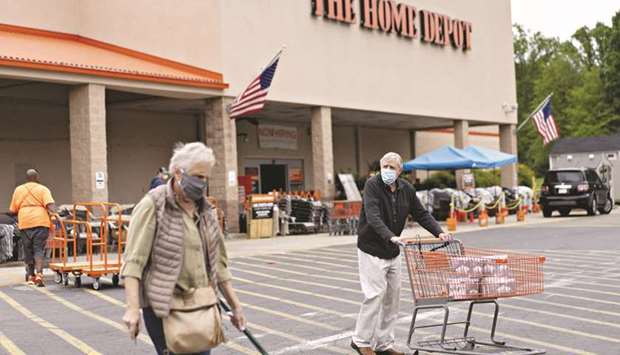 A customer pushing a cart outside a Home Depot store in Reston, Virginia. The Labour Department said its consumer price index dipped 0.1% last month after plunging 0.8% in April, which was the largest decline since December 2008.