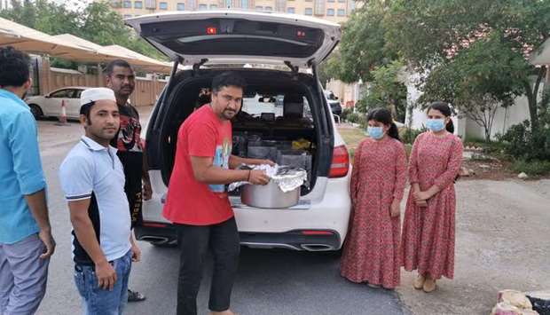 FOOD DISTRIBUTION: From right, Rawda seen with her sister and house staff while loading food to be distributed in the Industrial Area.