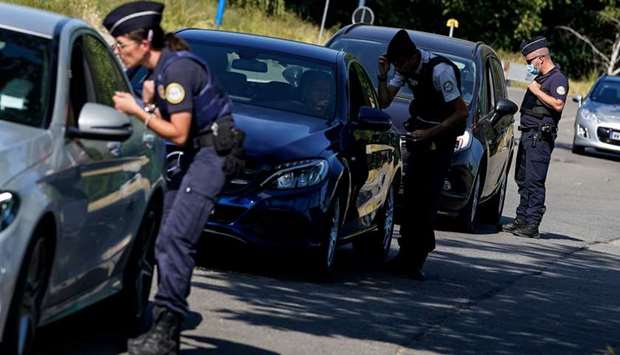 French border police officers speak with motorists at the Quievrain border crossing between France and Belgium. The border is closed to travellers moving without a valid reason.