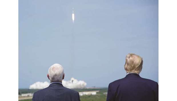 Vice President Mike Pence and President Donald Trump watch the SpaceX Falcon 9 rocket carrying the SpaceX Crew Dragon capsule, with astronauts Bob Behnken and Doug Hurley, liftoff from Kennedy Space Center in Florida on Saturday.