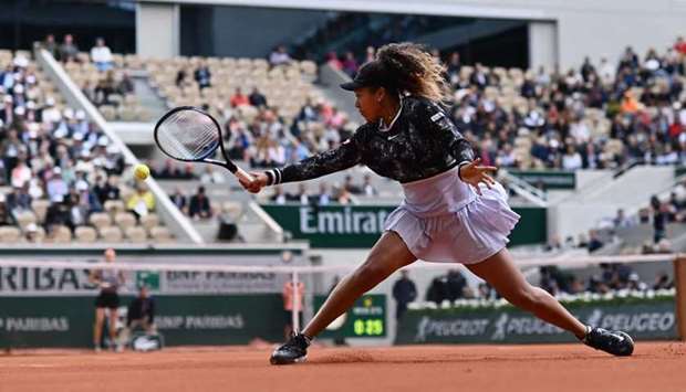In this May 28, 2019, picture, Japanu2019s Naomi Osaka hits a return against Slovakiau2019s Anna Karolina Schmiedlova in their first-round encounter at the French Open in Paris. (AFP)