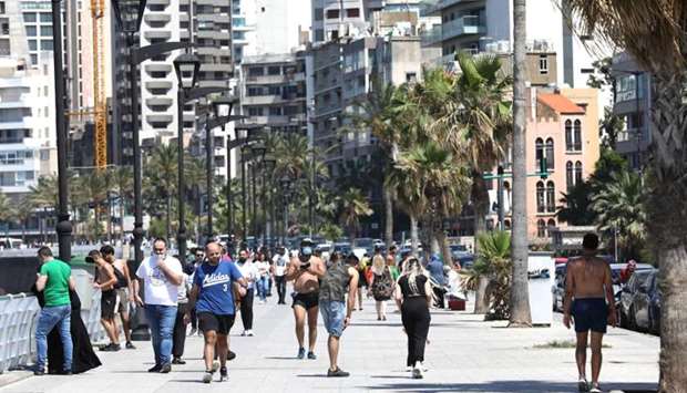 Residents of the Lebanese capital Beirut stroll along the seaside corniche, despite the lingering threat of the novel coronavirus