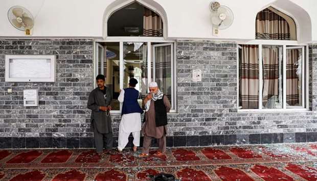Men inspect the site of a blast inside a mosque in Kabul, Afghanistan. Reuters