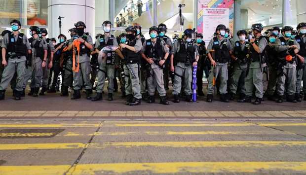 Riot police disperse stand guard as pro-democracy demonstrators take part a singing song protest at Mong Kok, in Hong Kong