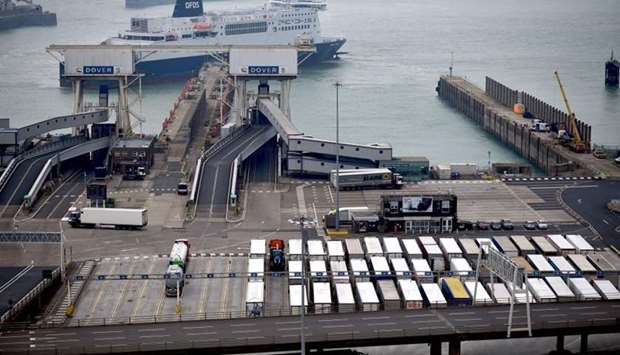 Freight lorries wait on the quayside to board a ferry, as a DFDS ferry arrives at the Port of Dover, in Dover on the south coast of England on June 12, 2020