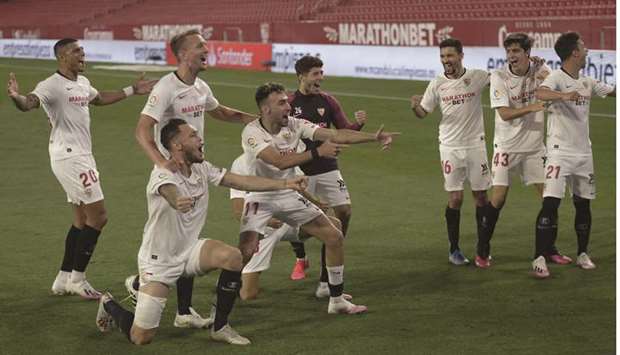 Sevillau2019s players celebrate at the end of the Spanish League football match against Real Betis at the Ramon Sanchez Pizjuan stadium in Seville on Thursday.