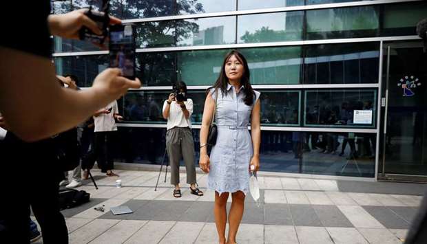 Kara Bos, whose Korean name is Kang Mee-sook when she was adopted in 1984 and is now seeking her biological parents, poses for photographs after attending her trial in front of a court in Seoul, South Korea, yesterday.