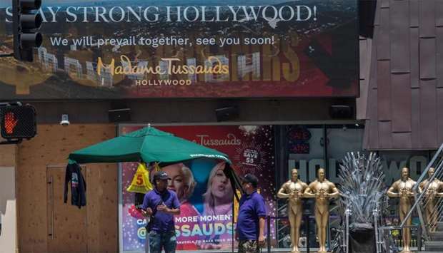 Visitors visit a newly opened tourist store which had been shut due to the Covid-19 virus, on Hollywood Blvd, Hollywood, California