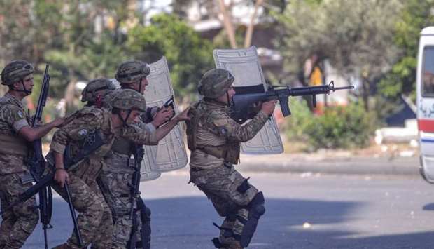 Lebanese army soldiers clash with anti-government protesters in the Bab al-Tabbaneh neighbourhood in the northern port city of Tripoli