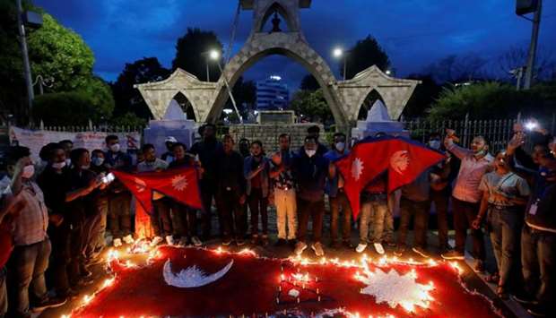 Nepalese people light candles as they celebrate after the parliament approved a new map of the country, including areas disputed with India, in Kathmandu, Nepal