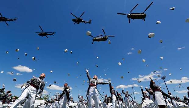 Graduating West Point cadets throw their hats in the air in celebration as US Army helicopters fly overhead at the culmination of their 2020 United States Military Academy Graduation Ceremony yesterday.