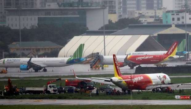 A VietJet Air passenger plane is seen on grass field after skidding at the Tan Son Nhat airport, in Ho Chi Minh city