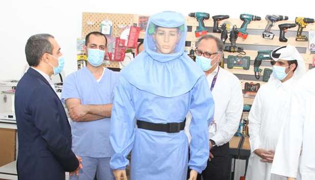 The specialist delegation from HMC being briefed about the new protective suit developed by QSC.
