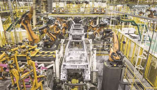 Robotic arms, manufactured by Kuka, work on the chassis of Trumpchi brand vehicles on a production line at the Guangzhou Automobile Group plant in Guangzhou. Industrial production in China expanded 4.4% last month, the Bureau for National Statistics (NBS) said, up from 3.9% in April, which was the first increase this year.