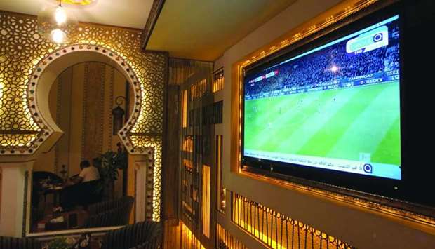 A TV broadcast of Bundesliga highlights, pirated by beoutQ, is seen at a local cafe in Khobar, Saudi Arabia.
