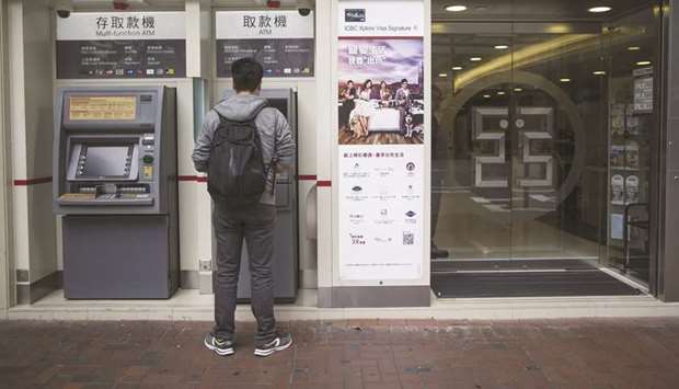 A customer uses an automated teller machine at an Industrial and Commercial Bank of China branch in Hong Kong. Chinese lenders led by ICBC more than doubled loans to businesses in the first quarter, while deferring and rolling over 1.5tn yuan in repayments.