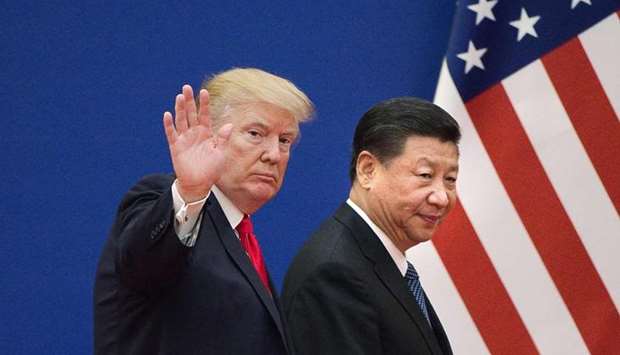 In this file photo US President Donald Trump (L) and China's President Xi Jinping leave a business leaders event at the Great Hall of the People in Beijing on November 9, 2017