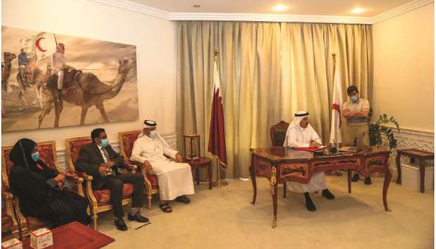 Ali bin Hassan al-Hammadi and other QRCS officials.