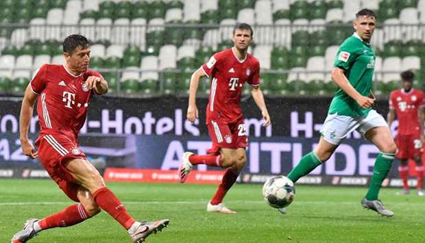 Bayern Munich forward Robert Lewandowski (left) scores against Werder Bremen during the Bundesliga match on Tuesday. (AFP)