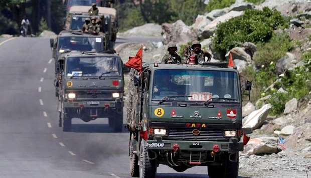 An Indian Army convoy moves along a highway leading to Ladakh, at Gagangeer in Kashmir's Ganderbal district on June 18