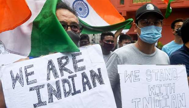 Indian citizens of Chinese origin hold placards and Indian national flags shouting slogans in support of the army during an anti-China demonstration in Kolkata