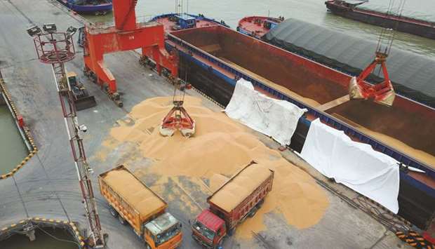 Workers load imported soybeans onto trucks at a port in Nantong, Chinau2019s eastern Jiangsu province (file).