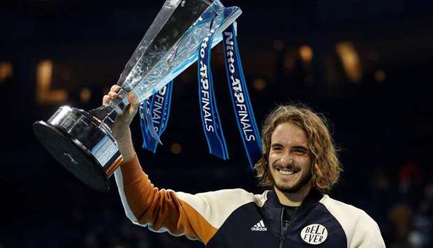 Greeceu2019s Stefanos Tsitsipas celebrates winning the ATP Finals with the trophy in London on November 17, 2019. (Reuters)