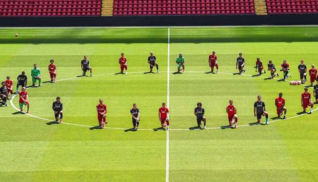 Liverpool players take a knee around the centre circle at Anfield yesterday. (Twitter/LFC)
