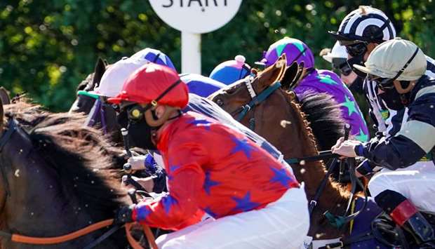 Jockeys ride the horses out of the starting stalls at Newcastle Racecourse in United Kingdom yesterday. (Reuters)