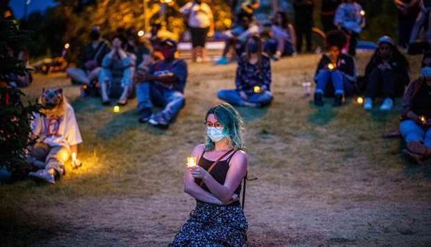People attend a candlelight vigil at an installation created by Anna Barber and Connor Wright called u2018Say Their Namesu2019 to honour victims of police brutality in Minneapolis.