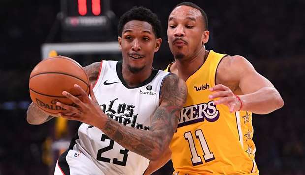 Avery Bradley (right) of the Los Angeles Lakers guards Lou Williams of the Los Angeles Clippers as he drives to the basket in the first half of the game at Staples Center on December 25, 2019 in Los Angeles, California. PICTURE: Getty Images/TNS