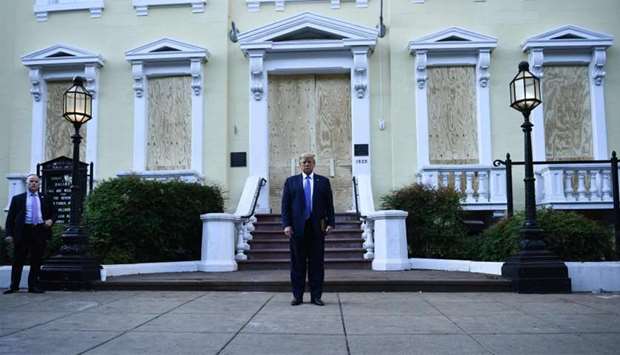 US President Donald Trump in front of boarded up St John's Episcopal church after walking across Lafayette Park from the White House in Washington