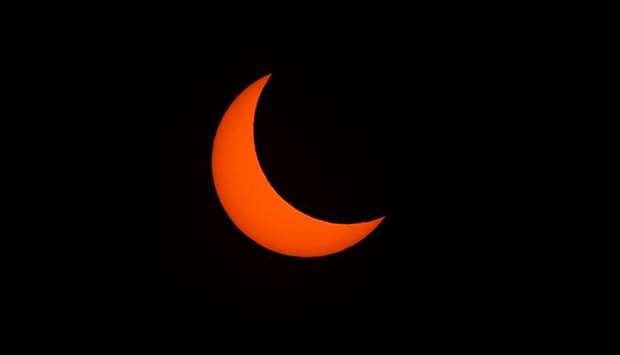 This picture shows the moon passing in front of the sun during an annular solar eclipse in Manila, yesterday.