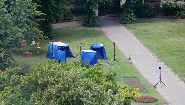 Police tents and equipment are seen at the scene of the fatal stabbing incident that is being treated as terrorism in Forbury Gardens park in Reading, west of London, yesterday.