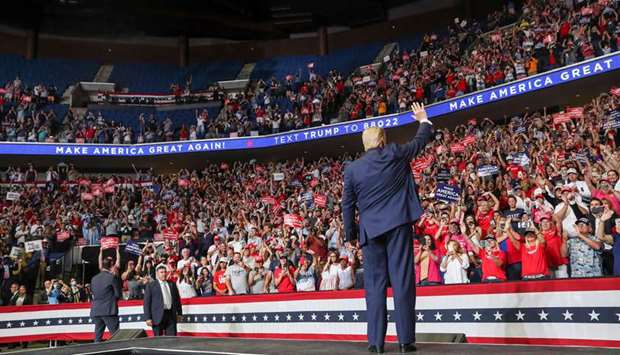 US President Donald Trump waves to supporters at his first re-election campaign rally at the BOK Center in Tulsa, Oklahoma, on Saturday night.