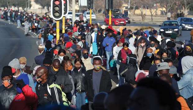 Stranded commuters wait for transportation at a bus terminal during a protest yesterday by taxi operators in Soweto.