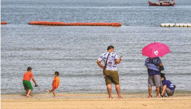 People enjoy the beach in Pattaya yesterday.