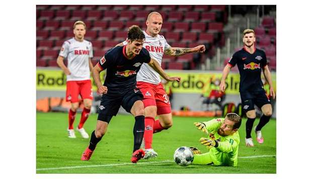 Leipzigu2019s forward Patrik Schick (left) and Cologneu2019s defender Toni Leistner (centre) and goalkeeper Timo Horn vie for the ball during the Bundesliga match in Cologne, Germany on Monday. (AFP)