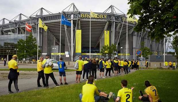 Brondby football fans observe social distancing while queuing outside the grounds for a match against FC Copenhagen at Brondby stadium, Denmark