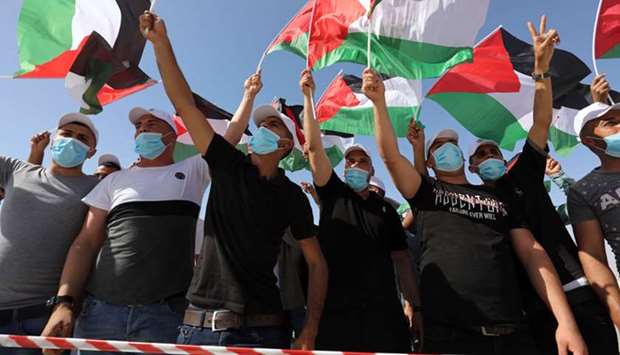Palestinians wave flags during a big rally called by Palestinian Authorityu2019s Fatah party to protest against Israelu2019s plan to annex parts of the occupied West Bank, in Jericho yesterday.