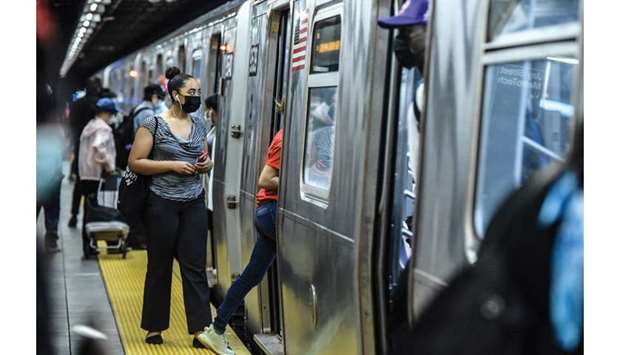 New Yorkers take the subway at a station in Brooklyn yesterday.