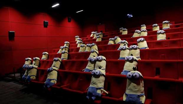 Minions toys are seen on cinema chairs to maintain social distancing between spectators at a MK2 cinema in Paris.