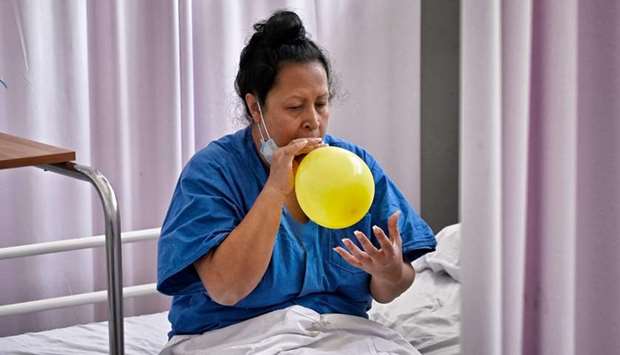 Suspected novel coronavirus patient Veronica Martinez, exercises with a balloon to strengthen her lungs in the Covid-19 hospitalisation operational unit of the Military Field 1, at the National Defence Secretariat in Mexico City.