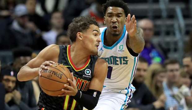 Malik Monk (right) of the Charlotte Hornets tries to stop Trae Young of the Atlanta Hawks during their game at Spectrum Center on December 8, 2019. (TNS)a