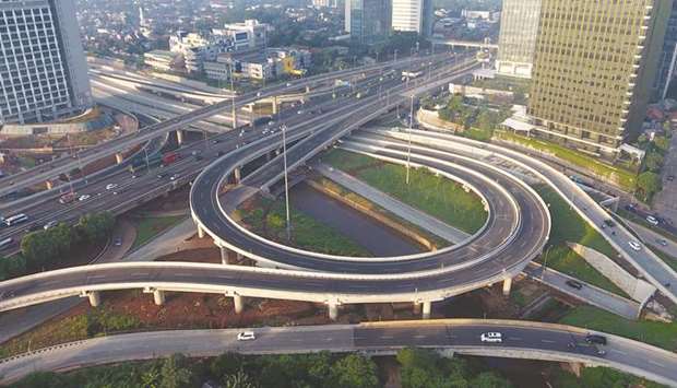 Vehicles travel along a highway in an aerial photograph taken in the Antasari area of Jakarta. Indonesian bonds appear more promising than Indiau2019s in a contest between Asiau2019s high-yield heavyweights, according to two of the worldu2019s biggest investment funds.