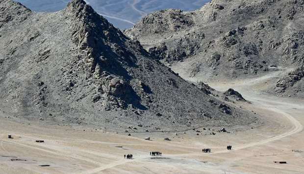 Indian soldiers walk at the foothills of a mountain range near Leh, the capital of Ladakh yesterday. Indian and Chinese military commanders during their meeting discussed ways to reduce frictions in the Ladakh region opposite Tibet.