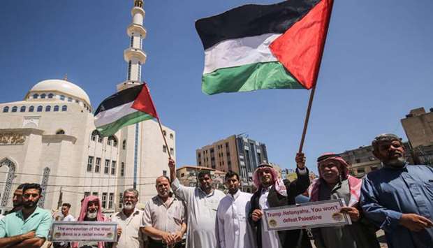 Palestinian protesters take part in a demonstration against Israelu2019s plans to annex parts of the occupied West Bank, in Khan Yunis in the southern Gaza Strip, yesterday.