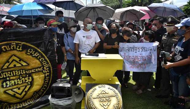 Pro-democracy activists gather to commemorate the anniversary of the 1932 Siamese Revolution, when Thailand transitioned to a constitutional monarchy system, outside Parliament in Bangkok yesterday.